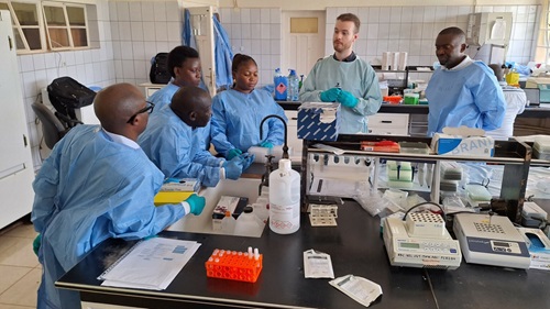 Researchers from the DRC, Rwanda and Burundi listen to researcher Luca Zaeck explain the theoretical principles of a test that detects antibodies against smallpox viruses.